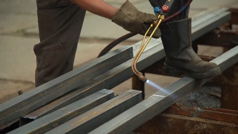 Worker uses welding machine to cut metal beam closeup Stock Footage 113395386