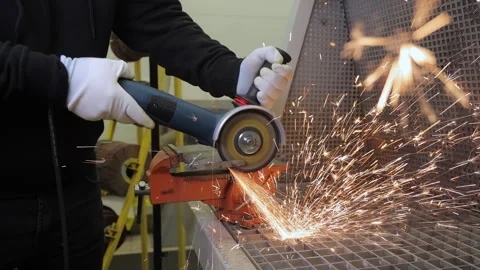 Worker Using Angle Grinder To Cut Metal With Bright Sparks Flying During Stock Footage 315385922