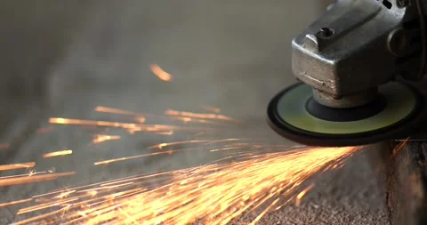 Worker using an angle grinder to cut metal with flying sparks. metalworking.. Stock Footage 340410055