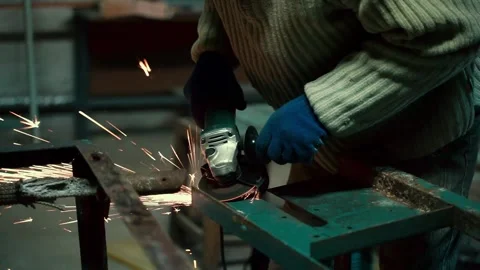 Worker Using Angle Grinder in Factory and throwing sparks. Video stock 347366154