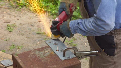 Worker Using Angle Grinder on Metal Plate Outdoors Stock-Footage 336213473