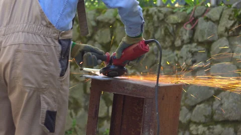 Worker Using an Angle Grinder on Metal Outdoors 스톡 동영상 336234402