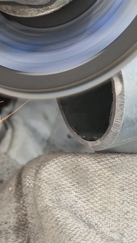 Worker Using Angle Grinder to Sand Metal Handrail Bracket Vertical Stock Footage 332874535