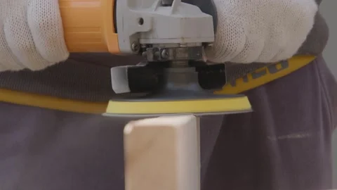 Worker Using Angle Grinder to Sand Wood Block Close-up Video stock 336561646
