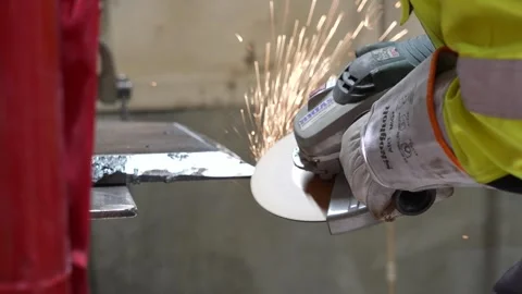 Worker using a angle grinder in a workshop Stock Footage 256087481