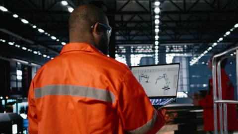 Worker using automation software connected to robot machinery Stock Footage 322202248