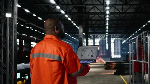 Worker using automation software connected to robot machinery Stock Footage 322202310