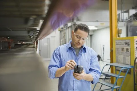 Worker using bar code reader in warehouse 写真素材