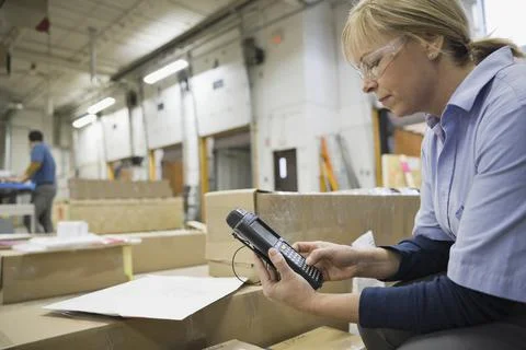 Worker using bar code reader in warehouse Stock Photos
