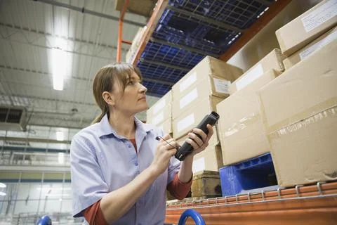 Worker using bar code reader in warehouse Stock-Fotos