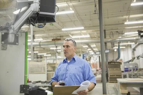 Worker using bar code scanner in factory Stock Photos