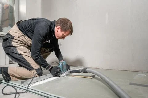 Worker is using a building tool, the milling tools and a vacuum cleaner. drywall Stock Photos