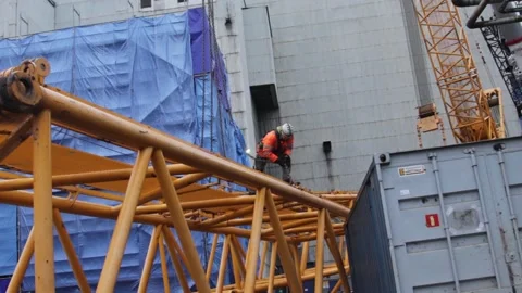 Worker using carabiner at the construction site of the coal-fired power station Stock Footage 137576579