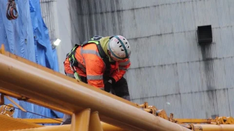 Worker using carabiner at the construction site of the coal-fired power station Stock Footage 137576590