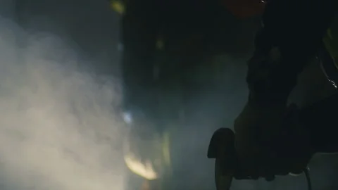 Worker using circular saw tool to grind concrete blocks with dust in darkness Stock Footage 130256551