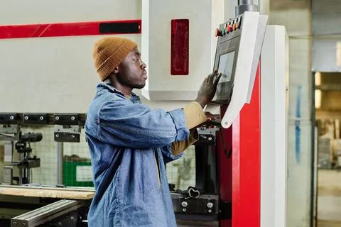 Worker using computer to control the machine Stock Photos