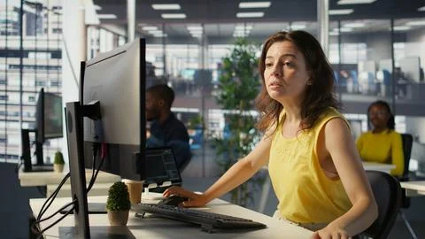 Worker using computer during job shift, being interrupted by manager Stock Photos
