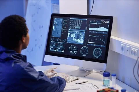 Worker using computer with scientific data in laboratory Stock Photos