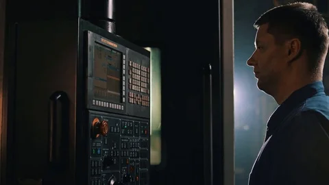 Worker using control panel on computer numerical control at production hall Stock Footage 83427907