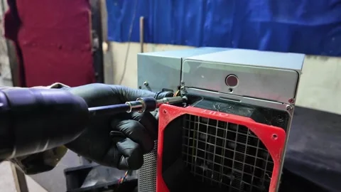 Worker Using Cordless Drill to Assemble Mining Machine Component Stock Footage 327467278