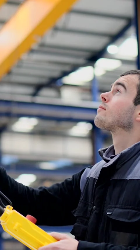 Worker using crane control in a factory Stock Footage 271100793