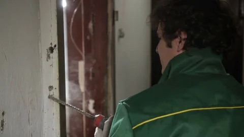 Worker using drill for dismantling old door Stock Footage 70913206