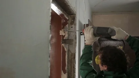 Worker using drill for dismantling old door Stock Footage 70913359