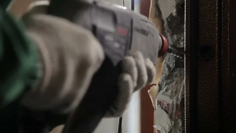 Worker using drill for dismantling old door Stock Footage 70914053