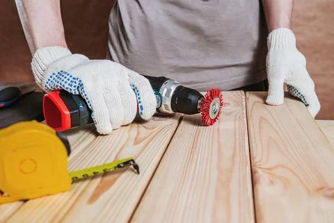 Worker Using Drill With Wire Brush On Wood Plank Stock Photos