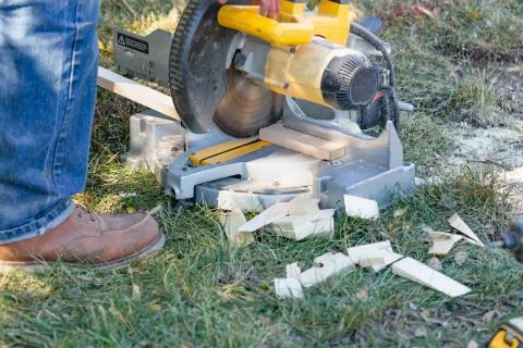 Worker Using Electric Miter Saw At Constrcution Site Stock Photos