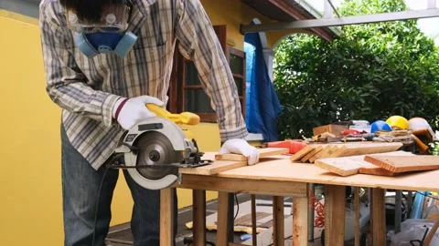 Worker using electrical saw cutting wood. Stock Footage 134166859