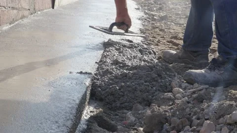 Worker using float trowel to level surface of concrete Stock Footage 220987645