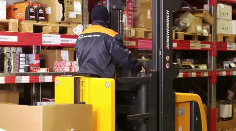 Worker using a forklift truck to move Cardboard box inside a storage warehouse 库存影片 54970838