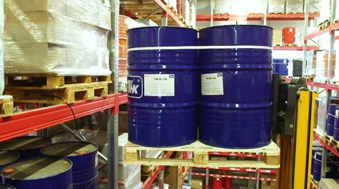 Worker using a forklift truck to move barrels inside a storage warehouse Stock Footage 54971551