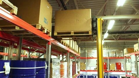 Worker using a forklift truck to move Cardboard box inside a storage warehouse Stock Footage 54972817