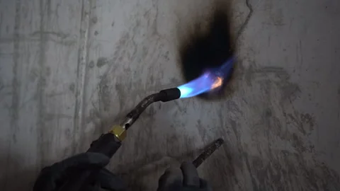 Worker Using Gas Blowtorch to Heat Concrete Wall Penetration with Audio Vídeos de archivo 334947196