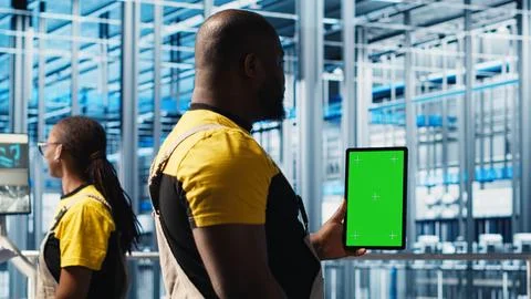 Worker using green screen laptop in smart factory, collecting and analyzing data 写真素材