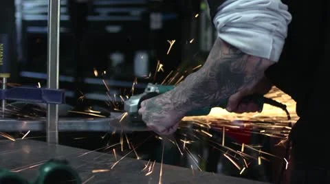 Worker using grinder on metal. Shooting Sparks. Stock Footage 12660165