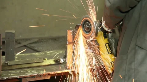 Worker using a grinder on piece of steel making sparks Stock Footage 62357591