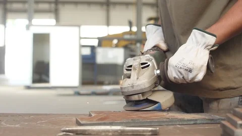 Worker using a grinder on piece of steel making sparks slow motion Stock Footage 83058634