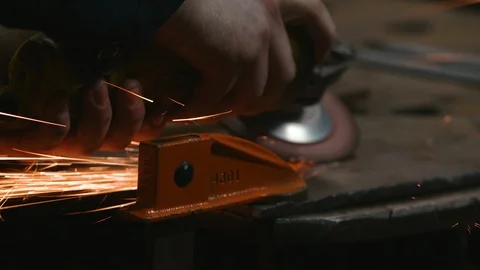 Worker using a grinding machine in the metal workshop Stock Footage 117718807