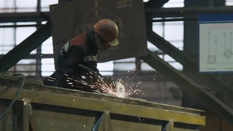 Worker using the grinding tool for component manufacturing at the facility Stock Footage 206154816