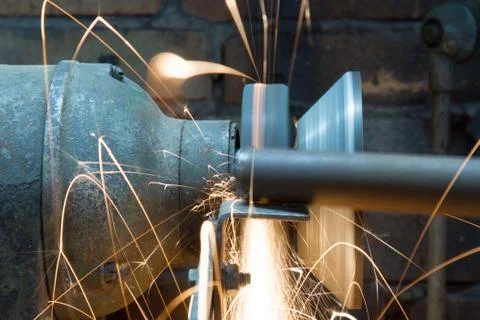 Worker using grinding wheel in workshop Stock Photos