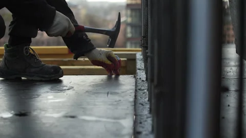 Worker using hammer on formwork at construction site Stock Footage 296123901