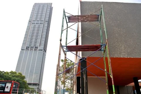 Worker using high-rise skyscraper in exhibition area Stock Photos