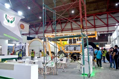 Worker using high-rise skyscraper in exhibition area Stock Photos