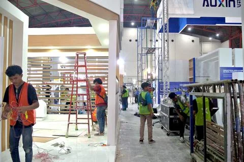 Worker using high-rise skyscraper in exhibition area Stock Photos
