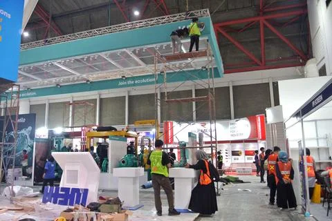 Worker using high-rise skyscraper in exhibition area Stock Photos