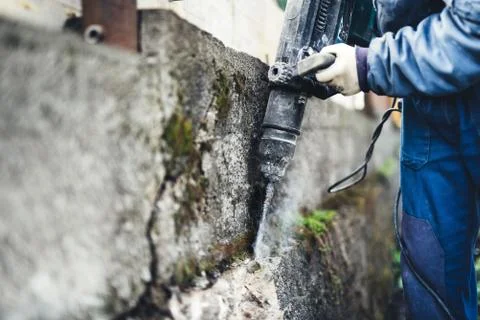 Worker using industrial construction tool, industrial jackhammer Stock Photos