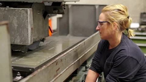 Worker using an industrial disc cutting machine Stock Footage 258397632